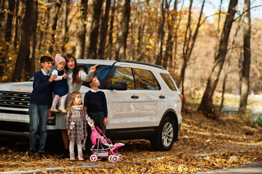 Image of mom and children next to car 